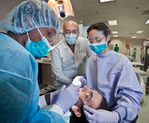 dental students and faculty working on patient