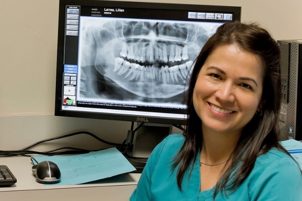 smiling student looking at x-rays